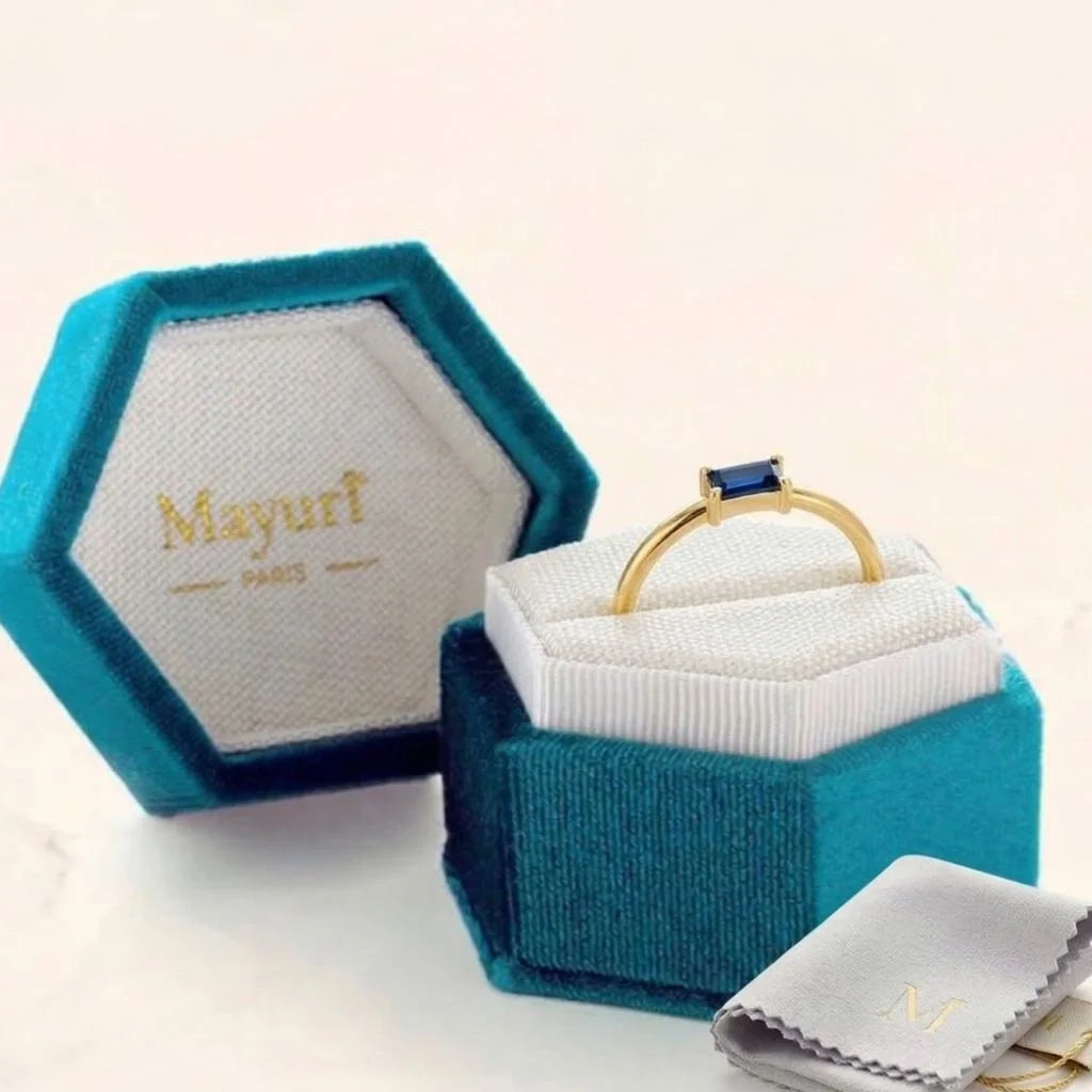 Anillo de zafiro guardado en un estuche de joyeria Mayuri de terciopelo con bolsa de almacenamiento