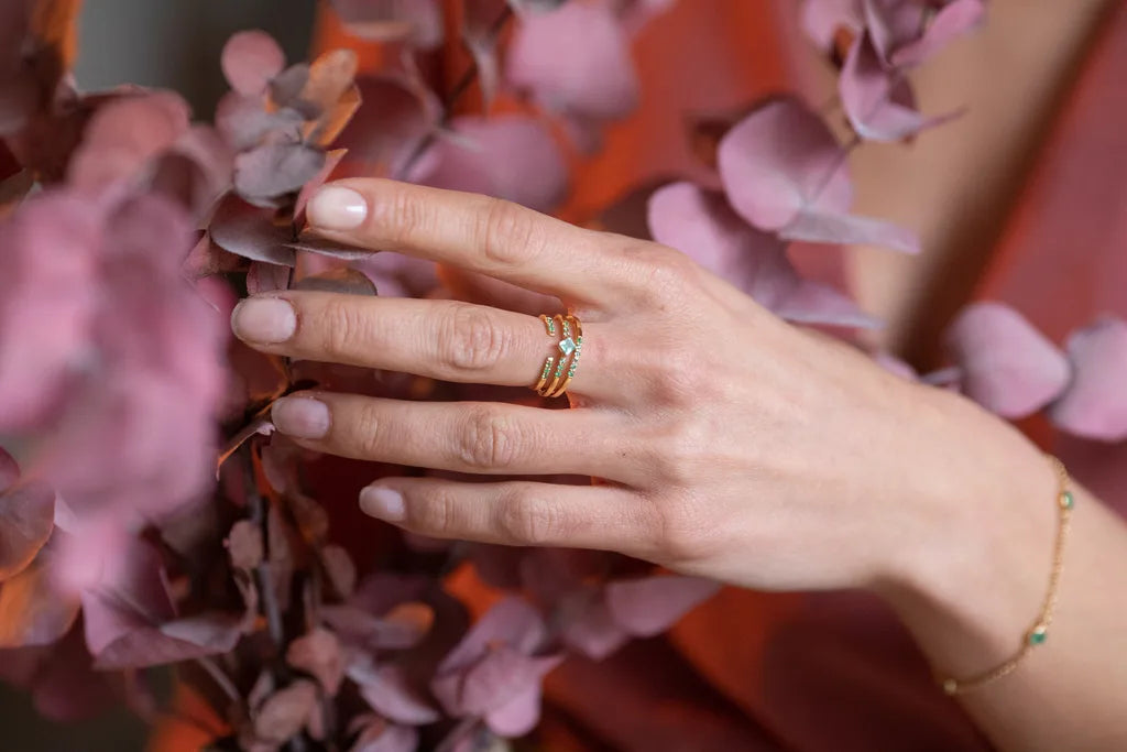 Colección de anillos con Esmeralda y diamantes engastados en oro amarillo 18 quilates Mayuri, llevados en el dedo