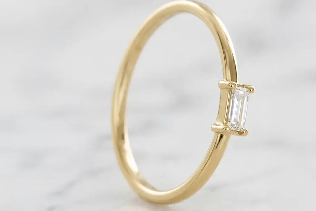 Anillo de compromiso solitario con diamante talla baguette en oro amarillo de 18 quilates por Mayuri